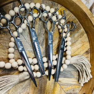 Hairdressing scissors set on wooden tray
