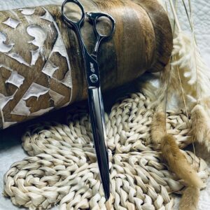 Black hairdressing scissors on woven coasters