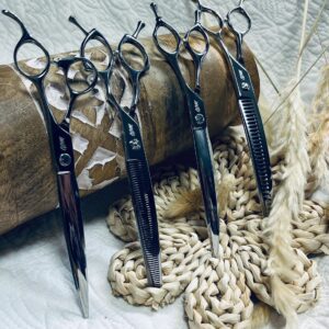 Five hairdressing shears on woven mat