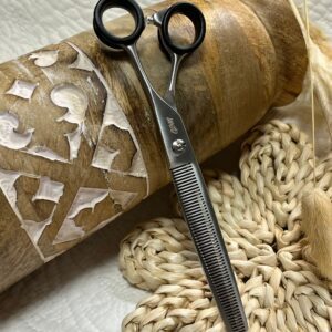 Thinning scissors on wooden decorative surface