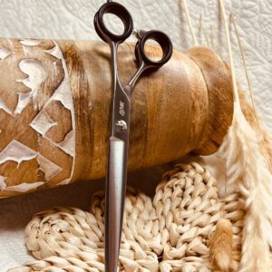 Silver hair scissors on woven mat and wood