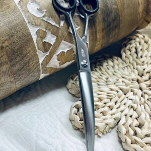 Silver hairdressing shears on woven placemat