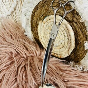 Silver hairdressing scissors on textured fabrics