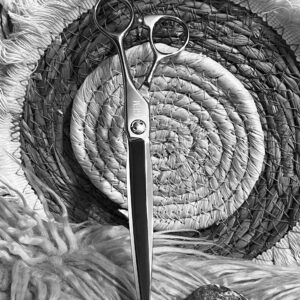 Hair scissors upright on woven round mat