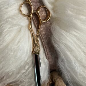 Gold ornate hair scissors on white fur