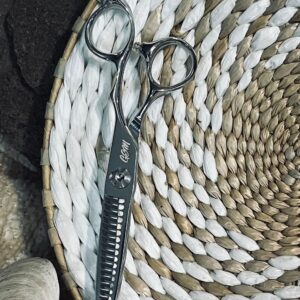 Silver thinning scissors on woven basket