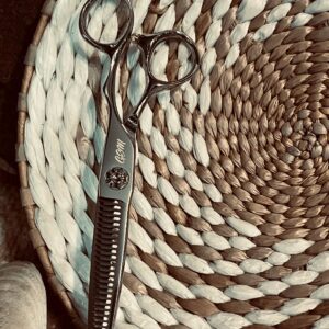 Silver thinning scissors on woven placemat