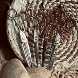 Set of hairdressing scissors on woven placemat